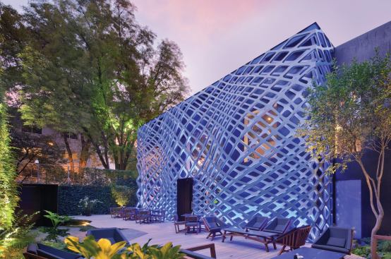 Blue lights illuminate the façade at night, creating a psychedelic appearance.