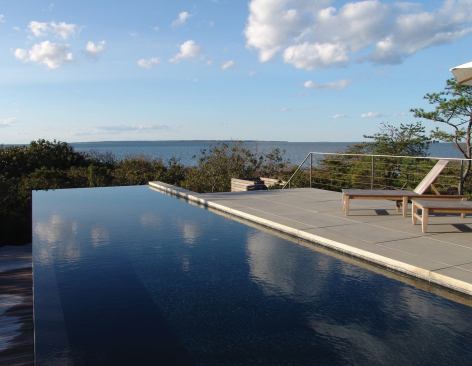 2008&nbsp;rada&nbsp;  custom / 3,500 square feet or less / grand  stelle architects   Fred Stelle, AIA, has boldly done what few architects dare to do—he's designed a house that plays second fiddle to its Long Island, N.Y., waterfront site. Seeking to capture views to the north and crucial natural light to the south, Stelle created a 90-foot-long glass box. The building's core, where the kitchen lies, opens up, transforming it and two adjacent decks into an outdoor room. And before they even reach such pleasures, guests must get out of their cars at a distance and follow a boardwalk (anchored with steel rods to withstand regular flooding) to the house. “In these waterfront sites, it's not only about trying to intervene as little as possible, but also about capturing the spirit of the place,” says Stelle, a veteran of building on Long Island.