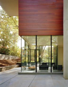 A wood-and-glass volume contains the living areas of the serene Matryoshka Residence in Bethesda.