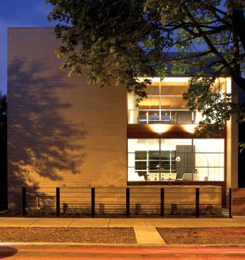 The home's front elevation celebrates the tension between opacity and transparency.