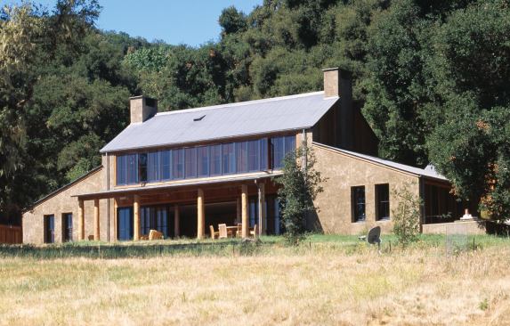 Sited to take advantage of the transition from open to wooded landscape, the main house/dining hall overlooks ranches in the valley below.