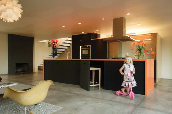 The large island anchoring the main living area conceals seven stools; its recycled rubber cladding is a durable, kid-safe surface.