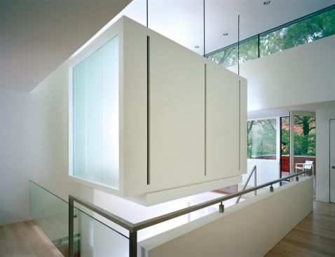 A floating meditation pavilion, supported from below by a shear wall, hangs from the ceiling of the Matryoshka Residence. 