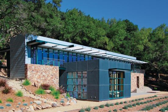 This modernist residence perches on the slope of Sonoma Mountain. Its stone walls use material excavated on site.

