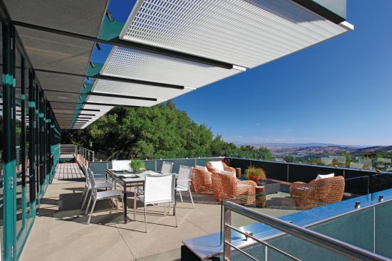 Aluminum screens shade an elevated deck overlooking the guest house and Sonoma Valley. 

