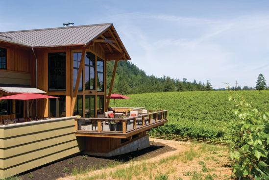 The two-story living room and wrap-around deck enjoy long views over the vineyards to Dry Creek Valley. 

