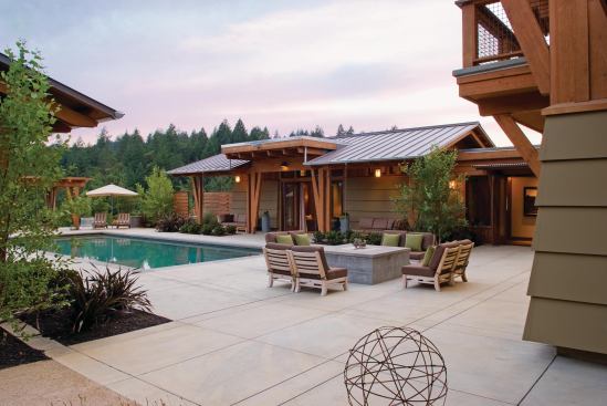 The main house and guest cottage enclose a courtyard/pool deck punctuated with planting beds. 


