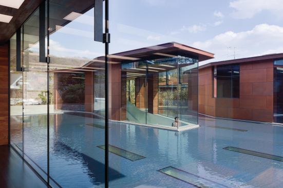 Rectangular skylights beneath the reflecting pool allow daylight to enter the gallery below.