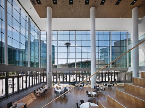Large public spaces, such as a four-story atrium, connect the site's three buildings to one another, as well as to some iconic neighbors.