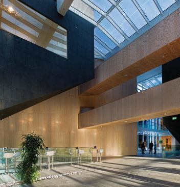 The dot patterning on the walls of House of Vestas serves double duty as an aesthetic treatment and a sound buffer, with acoustic dampers installed behind the panels.