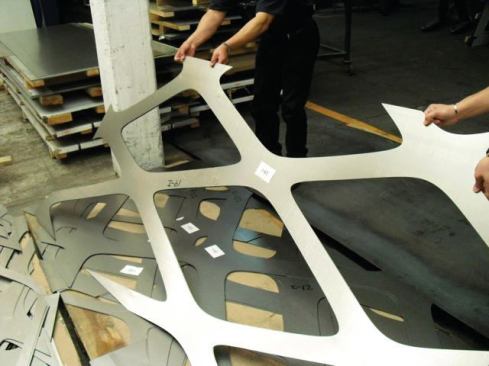 Organizing the CNC-milled steel pieces that comprise the façade.
