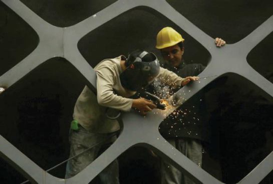 Workers welded the milled metal sheets to create the two planar surfaces comprising the façade.