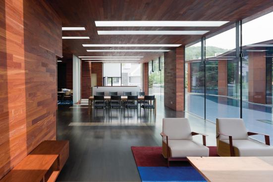 In the living pavilion, wood paneling covers ceiling and walls. 