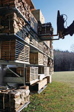 Forklift removing pallet from barn wall