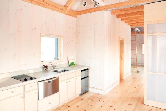 The kitchen is outfitted with a Danby 3.1-cubic-foot refrigerator and a Fisher & Paykel dishwashing drawer, both Energy Star-rated, a Verona stove, a Kohler Essex faucet, and locally crafted custom cabinets and concrete countertops.  