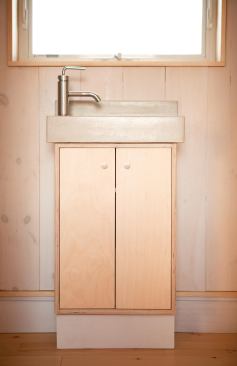 A WaterSense-certified Kohler Purist faucet tops a custom countertop and vanity in the BrightBuilt Barn's bathroom.
