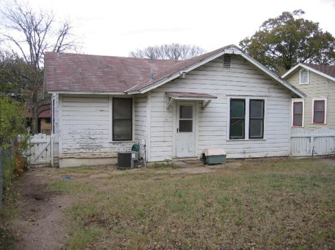 Before image showing the rear elevation and unappealing back yard. 