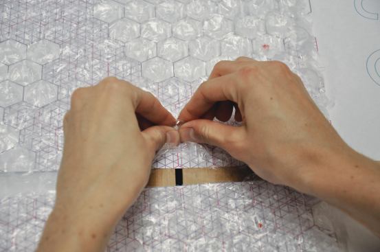 To help visualize the three-dimensional quality of the surface, the team went through a prototyping process that involved popping bubble wrap over a pattern of planned raised, flat, and depressed dots.