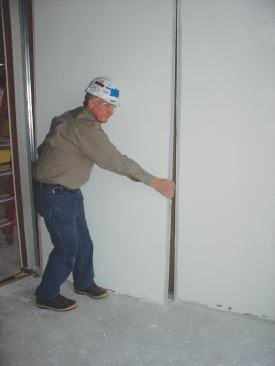 Demounting drywall for reinstallation elsewhere.