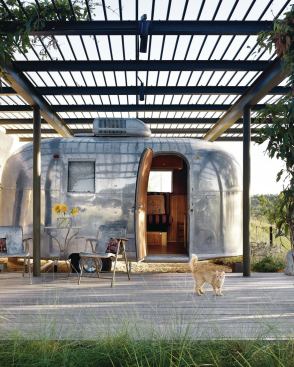 Through a wall opening is the restored Airstream, which was given a steel arbor and deck.