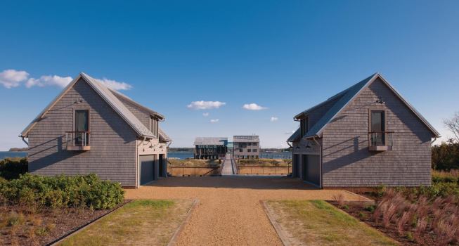 Twin garages make way for a bridge that connects to the main house, which sits upon the outline of a former oyster-shucking factory.