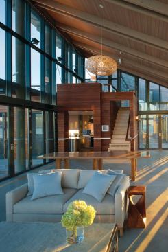 Living room stairs lead to the glass bridge that connects the main public areas with the more private spaces.