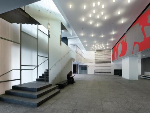 This lobby anchors what Billie Tsien terms a “Main Street” for the building—the path connecting the north and south entrances. The translucent panels enclosing the stair can double as a projection surface.