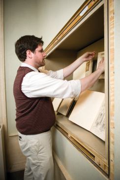 Gallery staffer Yuri Long installing the exhibition.