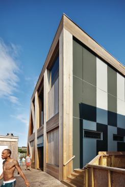 The north façade is lined with an inset pattern of Hardie Board panels. 