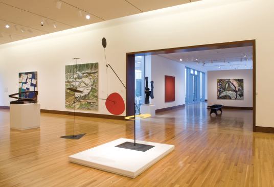 The museum's gallery spaces were designed to be minimal so as not to detract from the artwork, and feature neutral-colored walls, cove lighting, and wood floors. The façade treatment (alternating glazing and stone or terra-cotta) allows visitors to get glimpses of daylight as they walk between galleries.