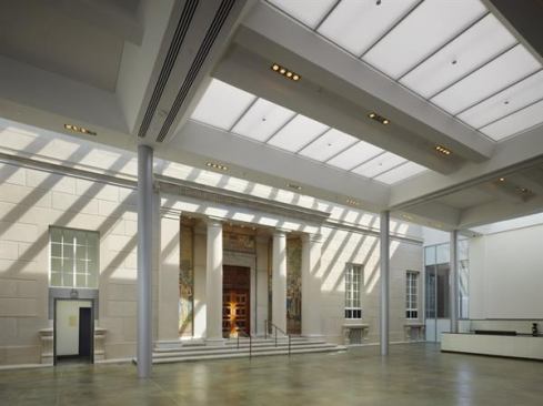 The original 1929 façade is preserved in a winter garden linking the south addition to the existing structure. Used as an event space, a café, and a welcome daylit respite from hard New Hampshire winters, the space features a large central skylight that contains two layers of perforated stretch vinyl fabric from NewMat, which help to cut down on glare and dampen the reverberant acoustics.