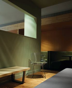 A secluded area at the back of the lounge provides seating for a small group adjacent to the booths that were reclaimed from the original Tiny Lounge.
