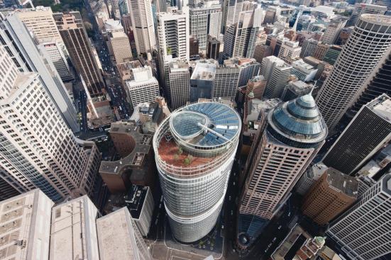 The building has a roof deck on level 28, solar thermal panels, and a grid-shell skylight that tops the glass-and-aluminum-lined central atrium.