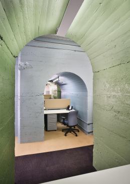 The basement level is used largely for faculty office space and special-education classes. Instead of erecting walls to create individual offices, the architects located faculty carrels around the massive poured-concrete arches that once served as a counterbalance to the generators and now bring a cloisterlike quality to the below-grade space.