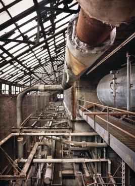 The top of the vast triple-height boiler room was originally capped with a glass skylight to allow daylight for the engineers working on the conglomeration of equipment below. 
