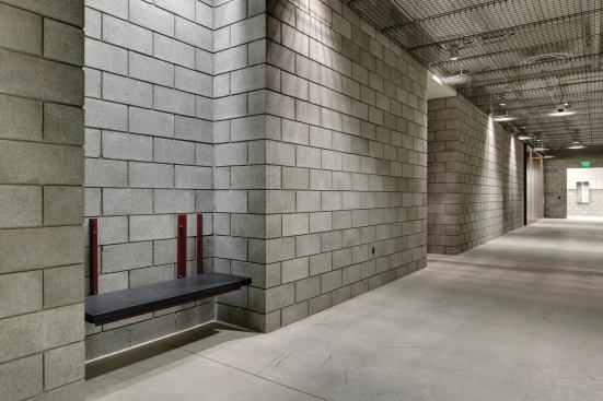 The wing’s main corridor is flanked by art-bearing niches and heavy Sapele-wood-plank doors that lead to offices, collections areas, and a seminar room. The ceiling is lined by the wire-and-aluminum ganglia of the massive HVAC system. 