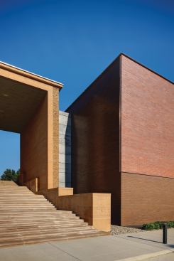 Above grade, the two volumes are connected via a thin joint of concrete block clad in galvanized metal. This joint hides the ductwork that feeds the new building. An interior passage between the old and new 

occurs below the stairs.