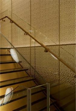 Gold mesh, patterned with the bamboo leaf motif, is sandwiched between glass panels that line the stairs that lead from the ninth-floor restaurant up to the 11th-floor private bar called Privé. 