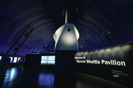 The Space Shuttle Enterprise is  exhibited in a 100-foot-long by 60-foot-wide air-supported structure on the flight deck of the aircraft carrier Intrepid.