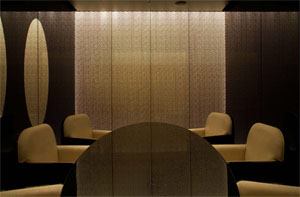 Like a fine piece of fabric that Armani would use to create a garment, gold mesh sandwiched in between glass panels form the walls of a private dining area in the restaurant.
