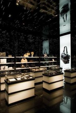 Case good merchandise in the Emporio Armani store areas is highlighted from a concealed slot system in the ceiling using CDMR111 lamps.