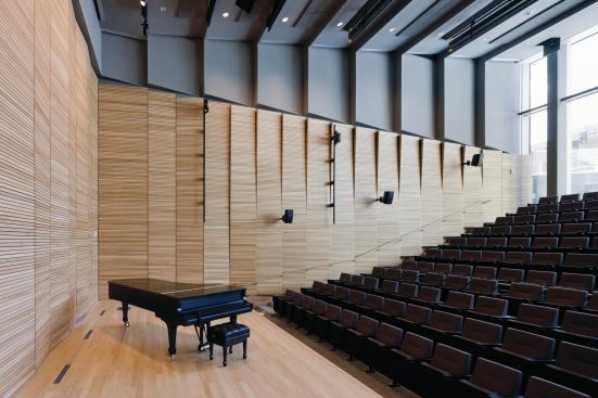 The ground-floor recital hall seats 218 and is acoustically tuned for live performances, but can also be used to screen films and as a lecture space. That flexible use of space continues on the fourth floor, with production spaces that can serve as dance studios, galleries, and projection spaces.