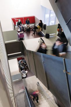 The floors are physically connected by a central stair with informal meeting spaces (termed living rooms) at each landing.