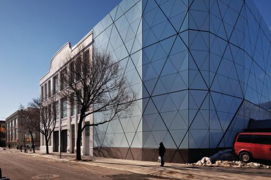 The blue panels echo the 3/16-inch-thick aluminum panels that quilt the façade of the new 47,000-square-foot addition at the back of the museum's original 1920s-era home.