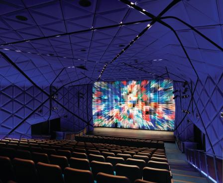 The main theater is lined in vaccuum-formed felt panels in International Klein Blue (named after artist Yves Klein, who first mixed the vivid ultramarine color) that control the acoustics. When a film is not being shown, the focal point is the multicolored curtain also designed by Cindy Sirko.