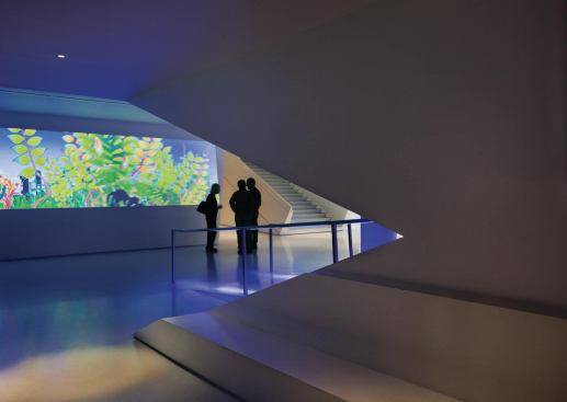 In a museum about moving images, projection space is at a premium. So the lobby (with its cast-polyester floors and white walls) doubles as a gallery with a 95-foot-long projection wall across from the theater entry. People in the public areas can use a central staircase for direct access to the exhibitions in the galleries upstairs.