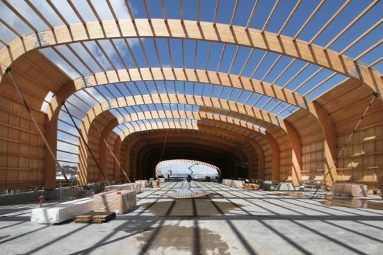 The glulam arches, spaced 23 feet o.c., serve as the roof's primary support. Between the beams, 757 purlins spaced 4 feet o.c. form the roof's secondary support.