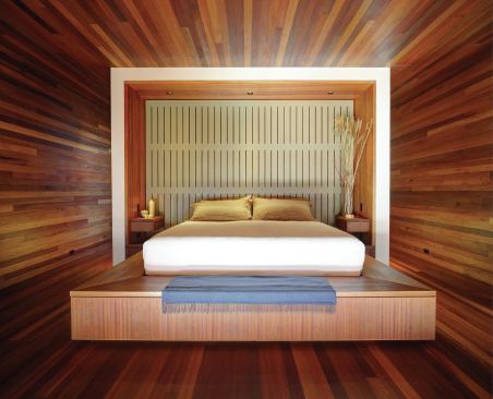 The master bedroom’s built-in headboard repeats the fireplace’s slatted pattern, but in leather instead of bronze.