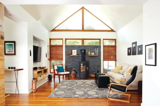 In Bork Newcomer's living room, the high-efficiency wood-burning Tula stove from Hearthstone Stoves can heat an area up to 1,300 square feet. The EPA-certified unit costs less than $6,000, Newcomer says, and provides consistent, added warmth during the winter to both levels of the house. Site-built clerestory and front triangle windows utilize insulated PPG Solarban 60 glass.