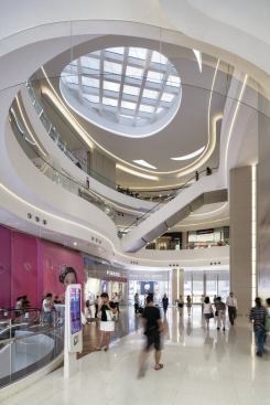 A network of escalators drive shoppers through the multilevel lower retail podium.